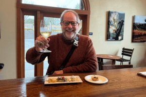 CHEF KIM TOASTING WITH A GLASS OF WHITE WINE 