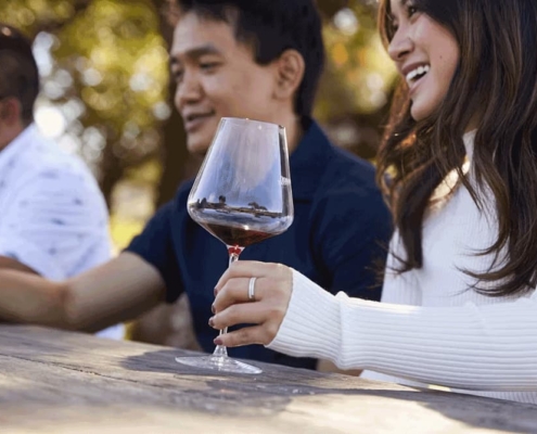 Woman holding red wine glass